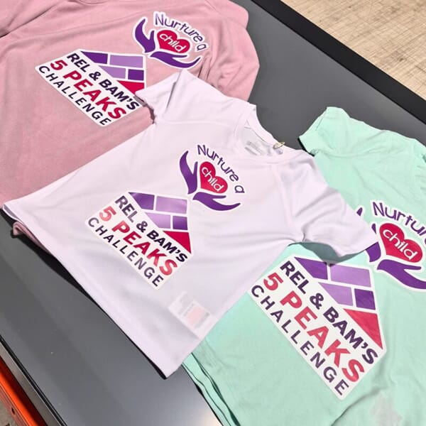An image of the Nurture a Child shirt in different colors.